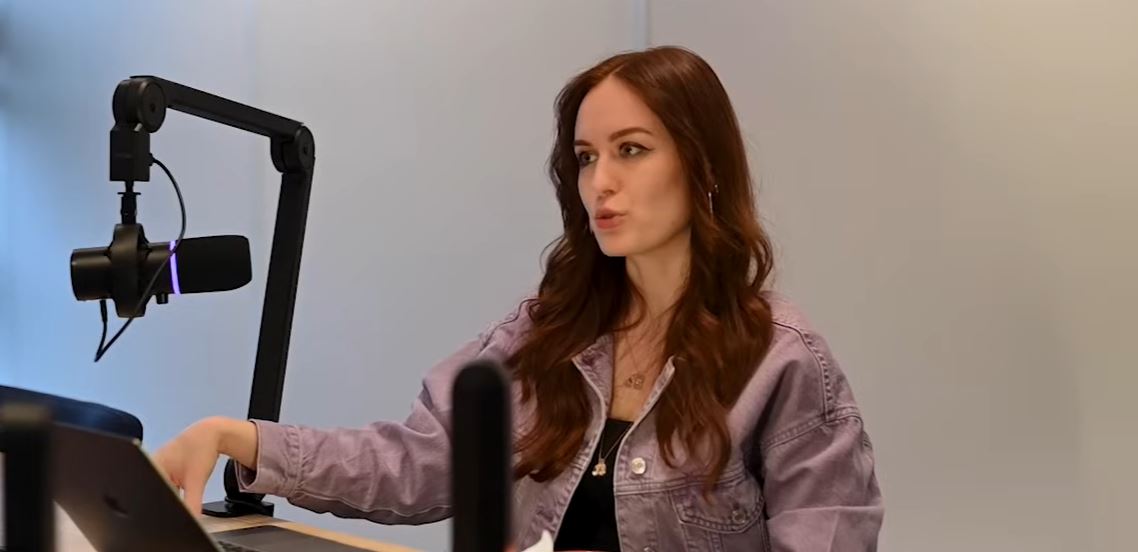 Viktoria hosting a podcast episode at a studio microphone